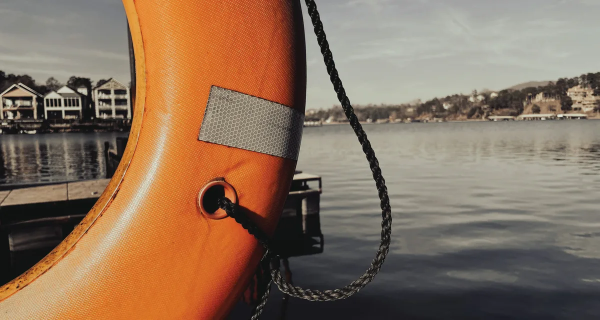 An orange life ring and rope, standard safety equipment