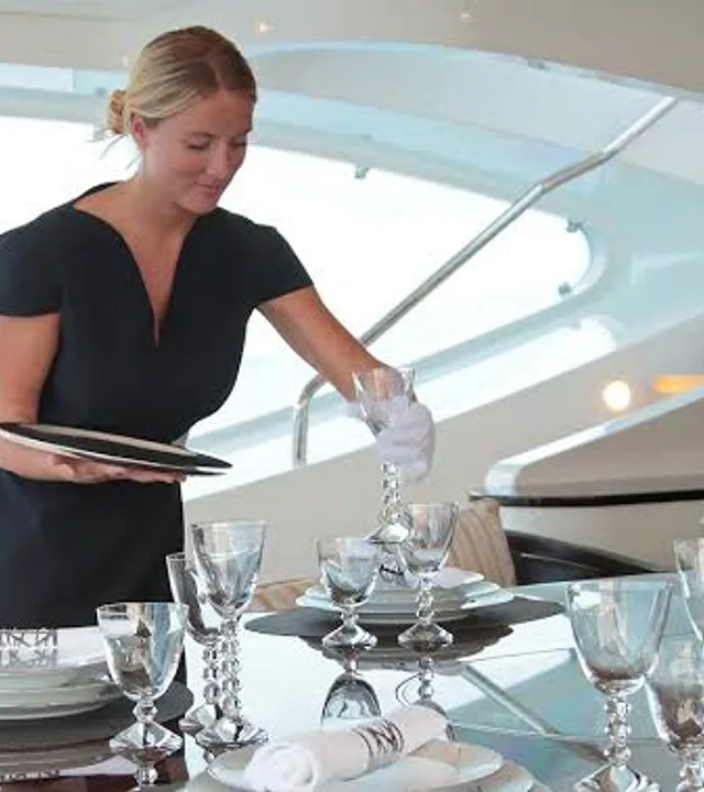 A stewardess setting a formal dining table
